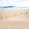 A beach shore with the word "vitamin D" written out in the sand