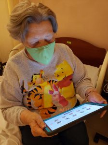 Resident using tablet provided by Project VITAL