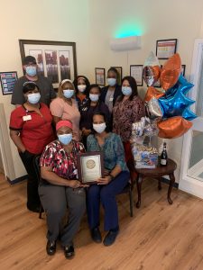 The Hunter Woods team proudly displays their AHCA quality award.