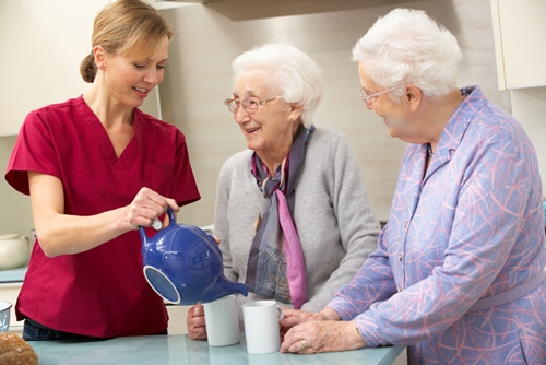 nurse serving tea to residents