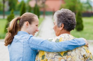 younger woman consoling elderly woman