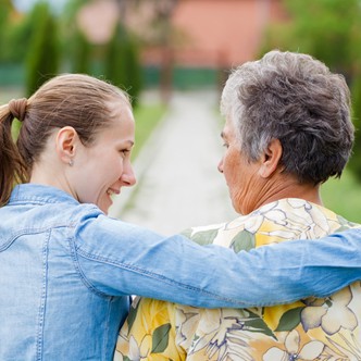 younger woman consoling elderly woman