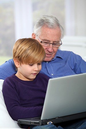 grandpa and grandson using laptop