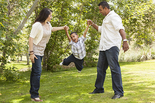 parents swinging child