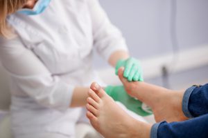 Health care provider examines a patient's feet